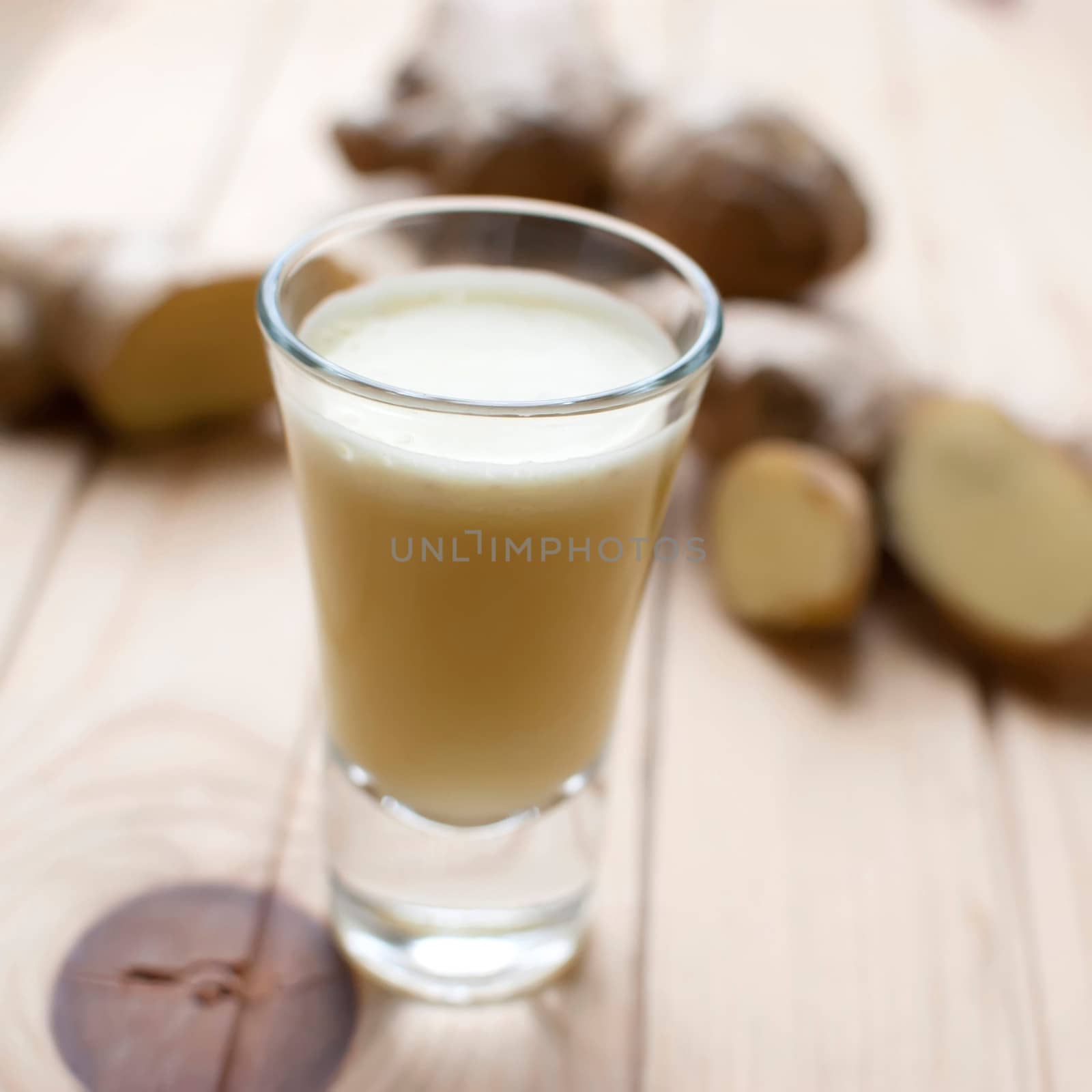 fresh organic healthy ginger shot juice and root