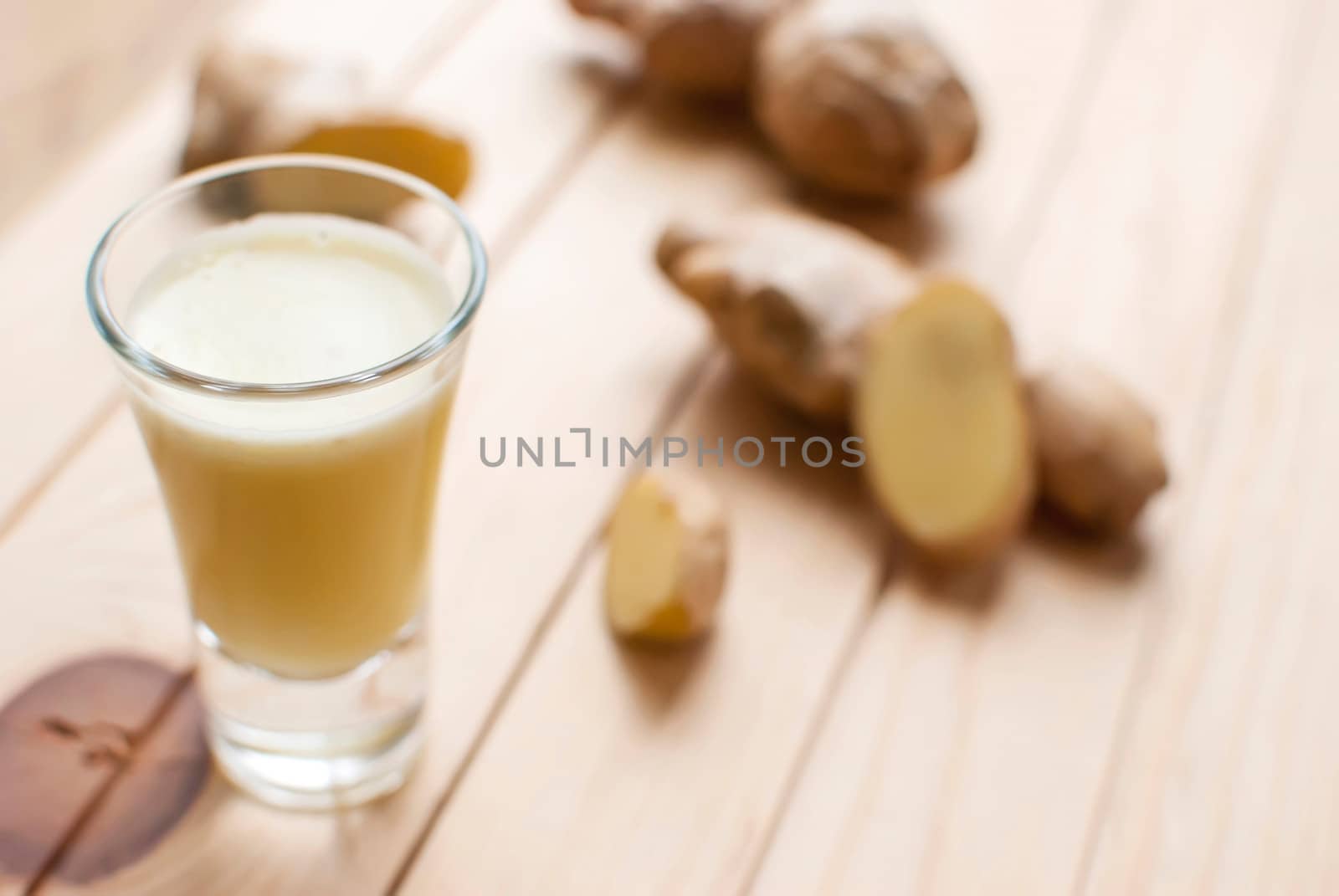 fresh organic healthy ginger shot juice and root