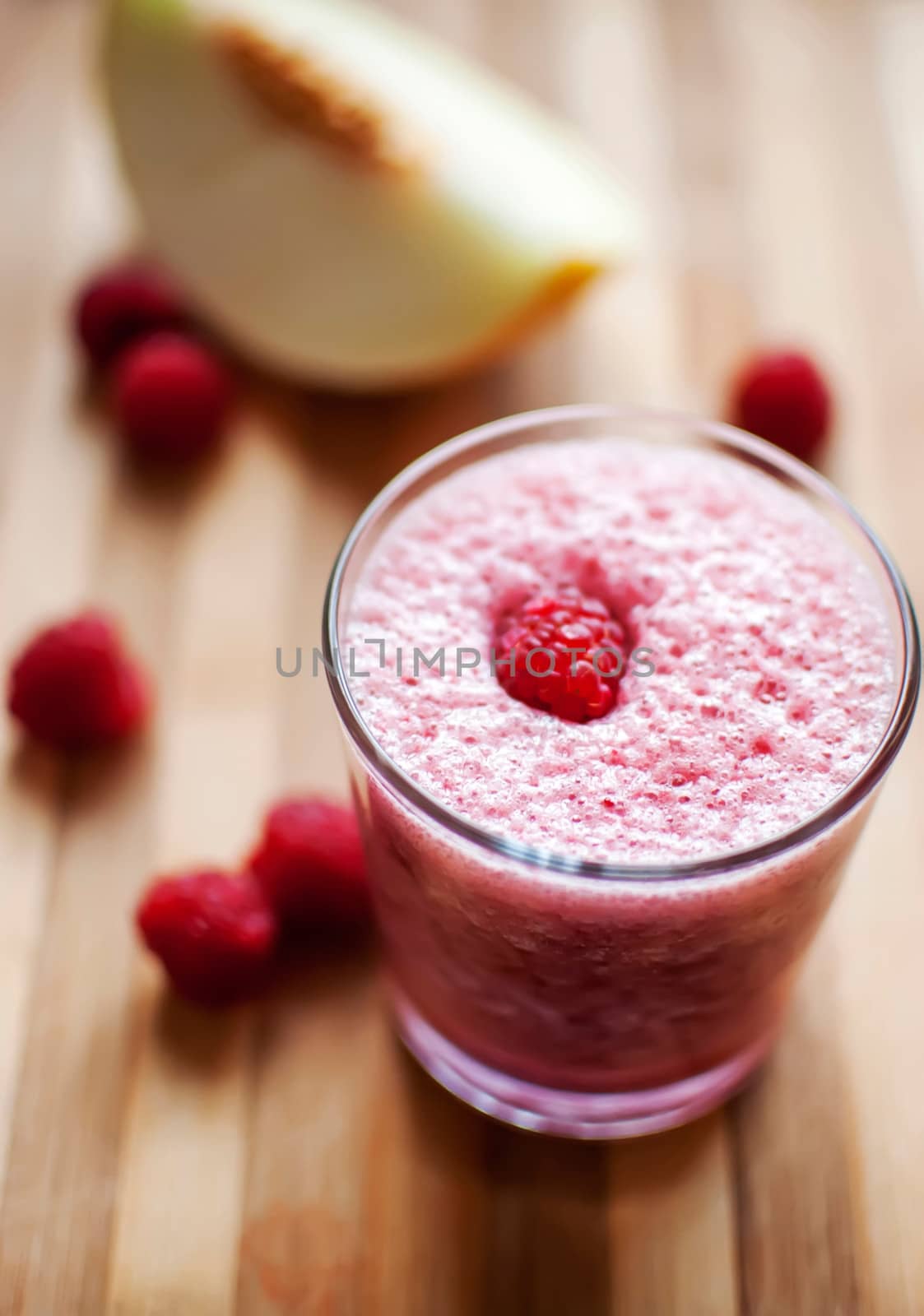 healthy raspberry and melon juice over wood