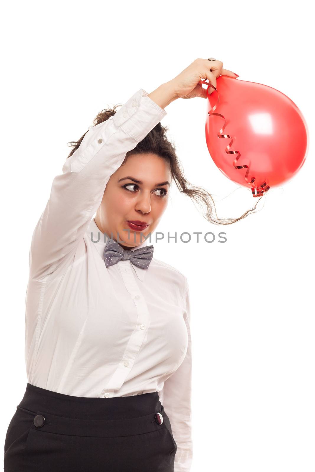 confident woman playing with balloon on white background