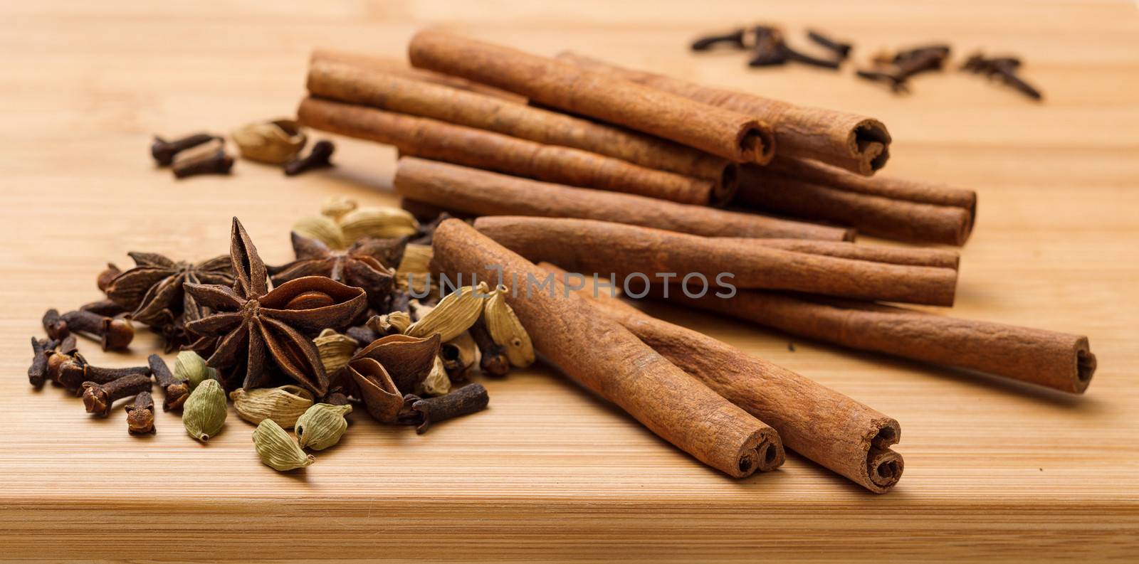 Dry multicolored spice closeup on wooden background