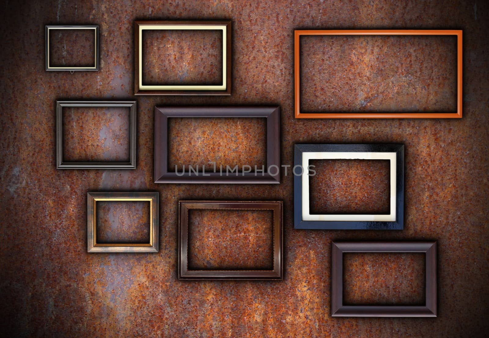 rusty wall full of empty frames ready for your design or message