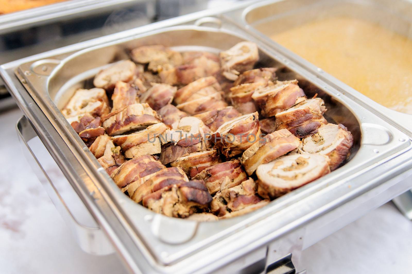 Pieces of pork roulade in a silver tray