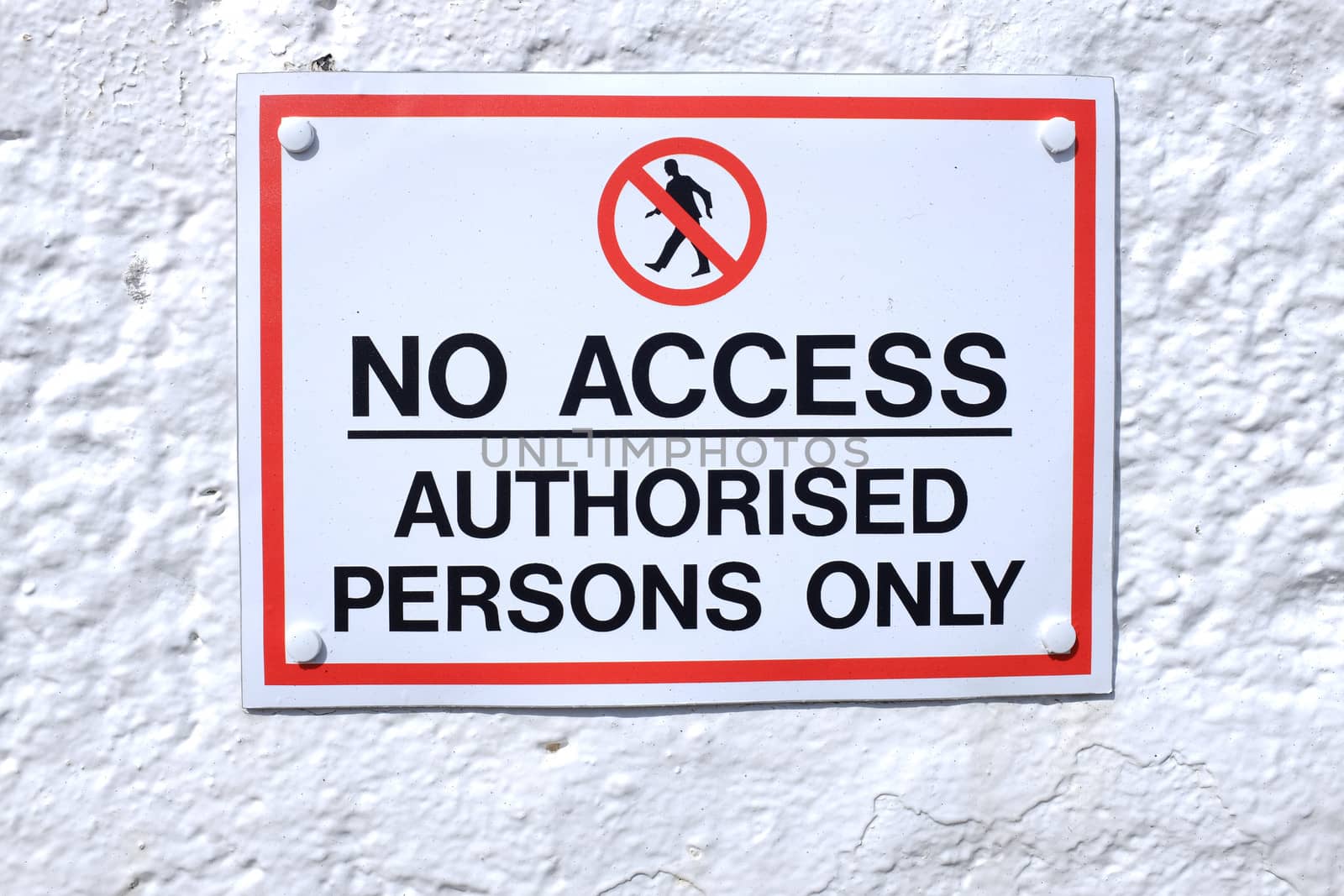 A sign with a white background and red rectangle with the words 'NO ACCESS AUTHORISED PERSONS ONLY' written in black and the symbol for no access above.