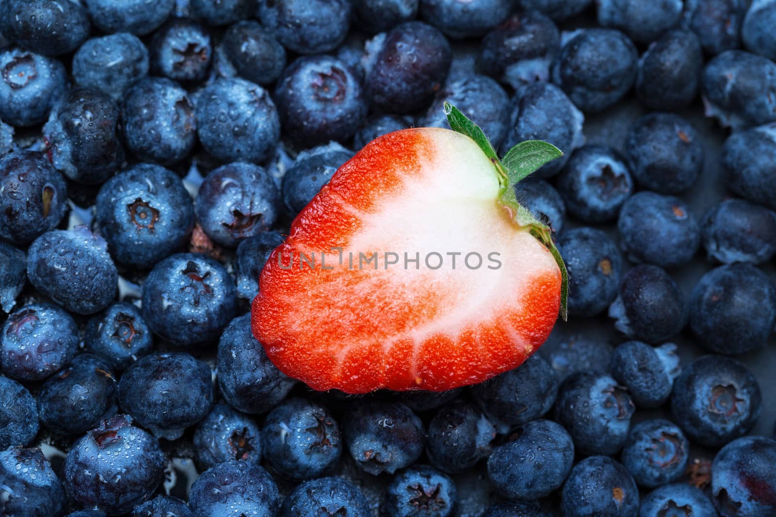 Freshly picked blueberries with strawberry, closeup background