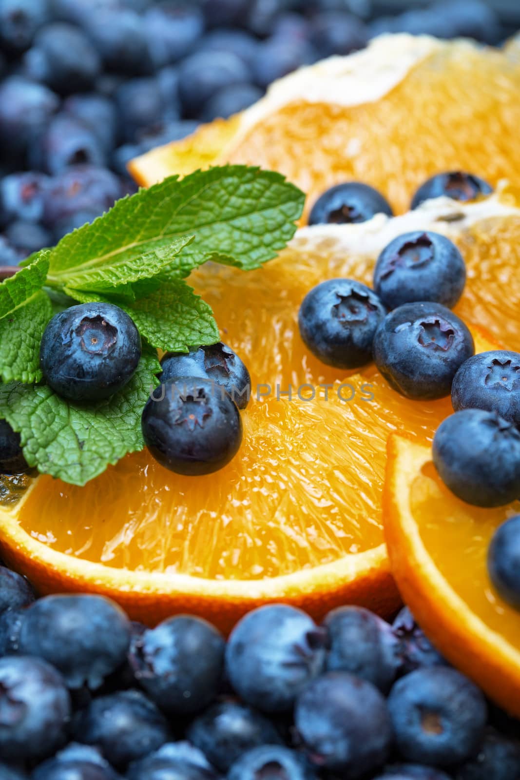 Freshly picked blueberries with orange by Discovod