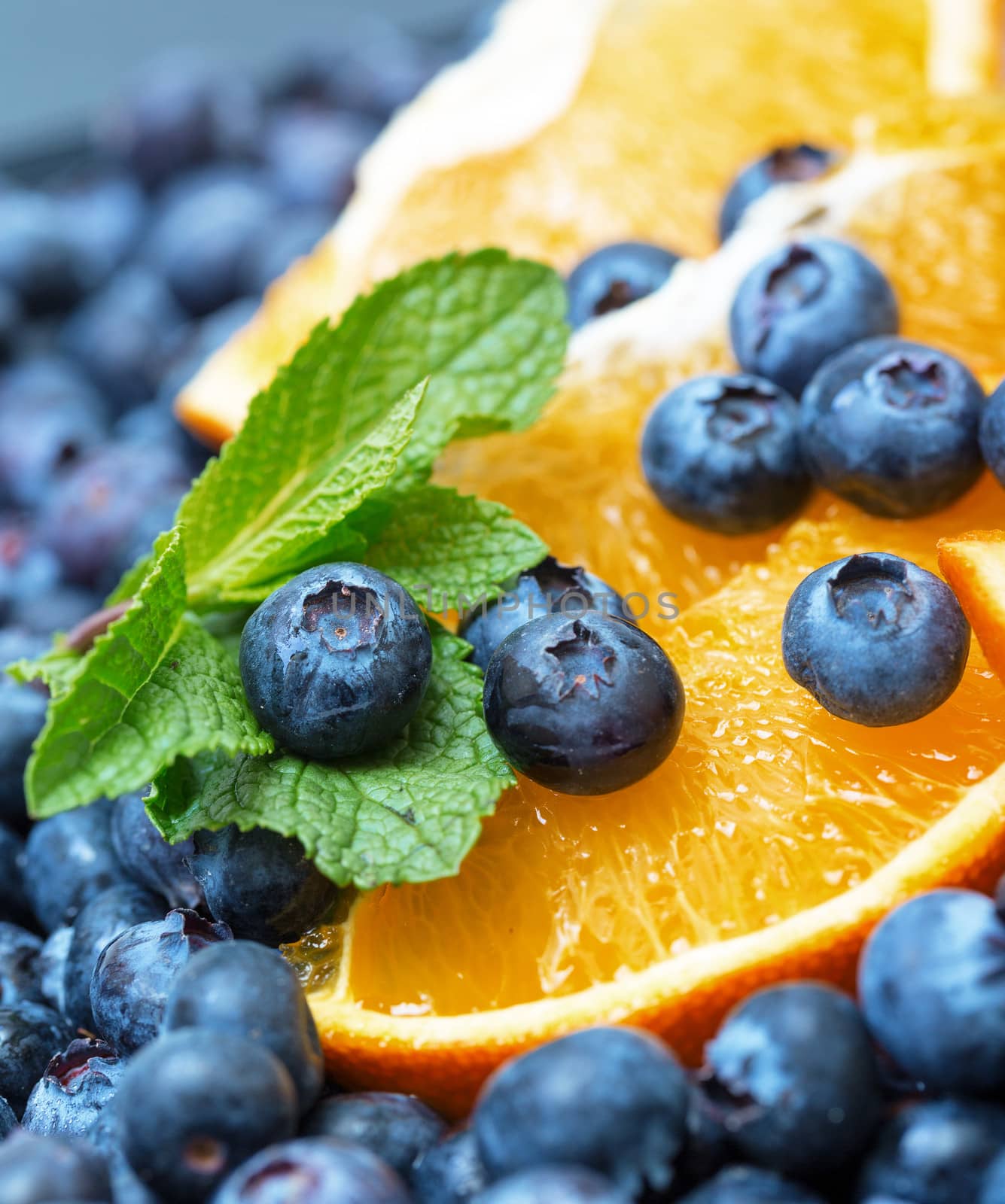 Freshly picked blueberries with orange by Discovod