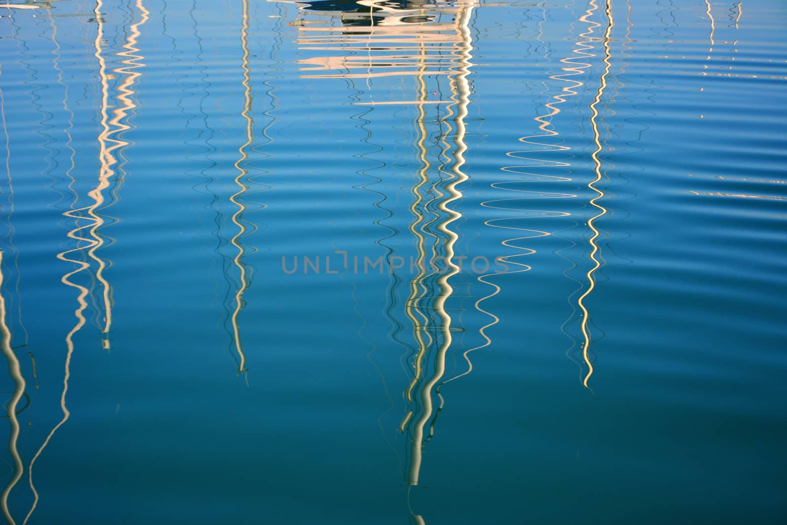 boat masts reflected in water