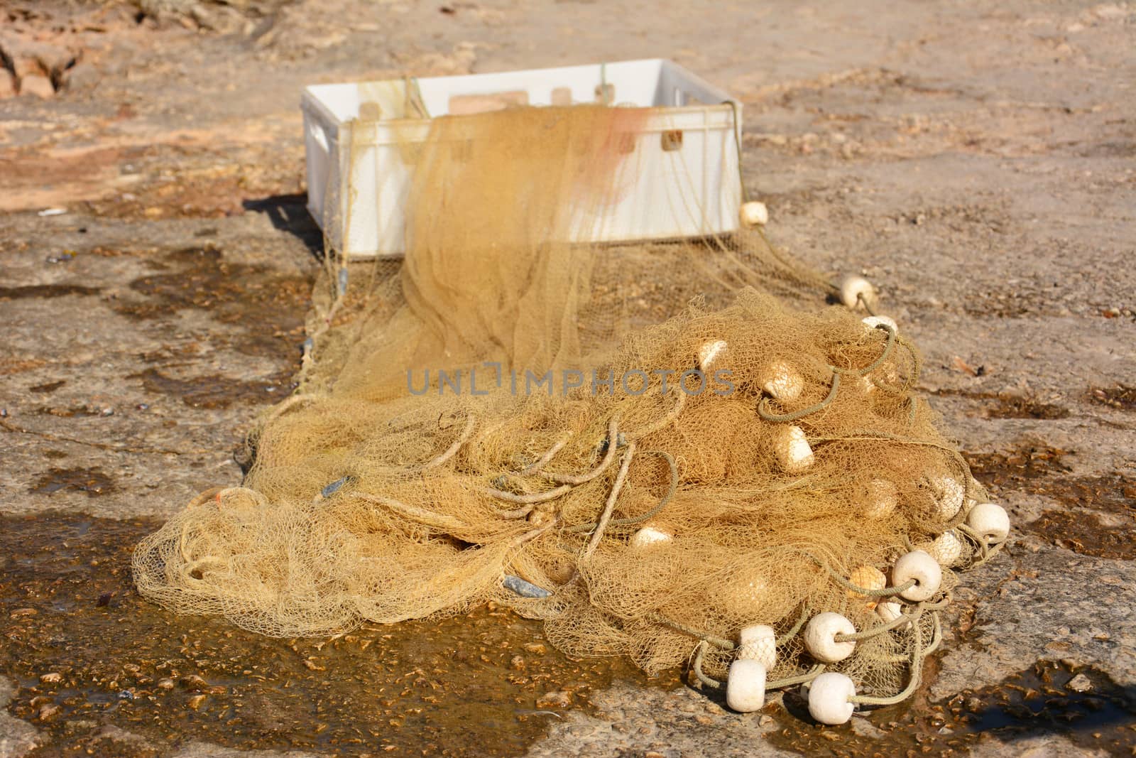 small fishing net on shore with white box