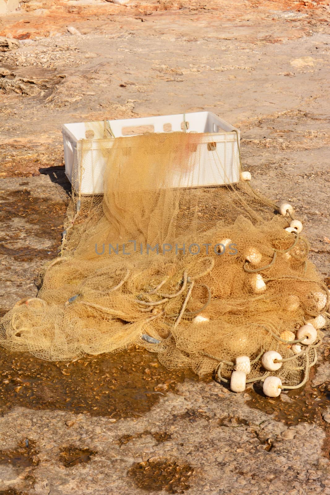 small fishing net on shore with white box