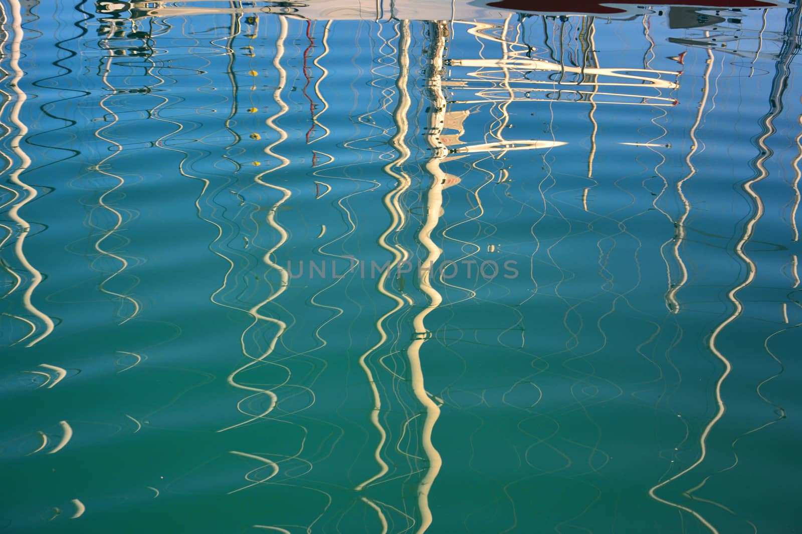 boat masts reflected in water