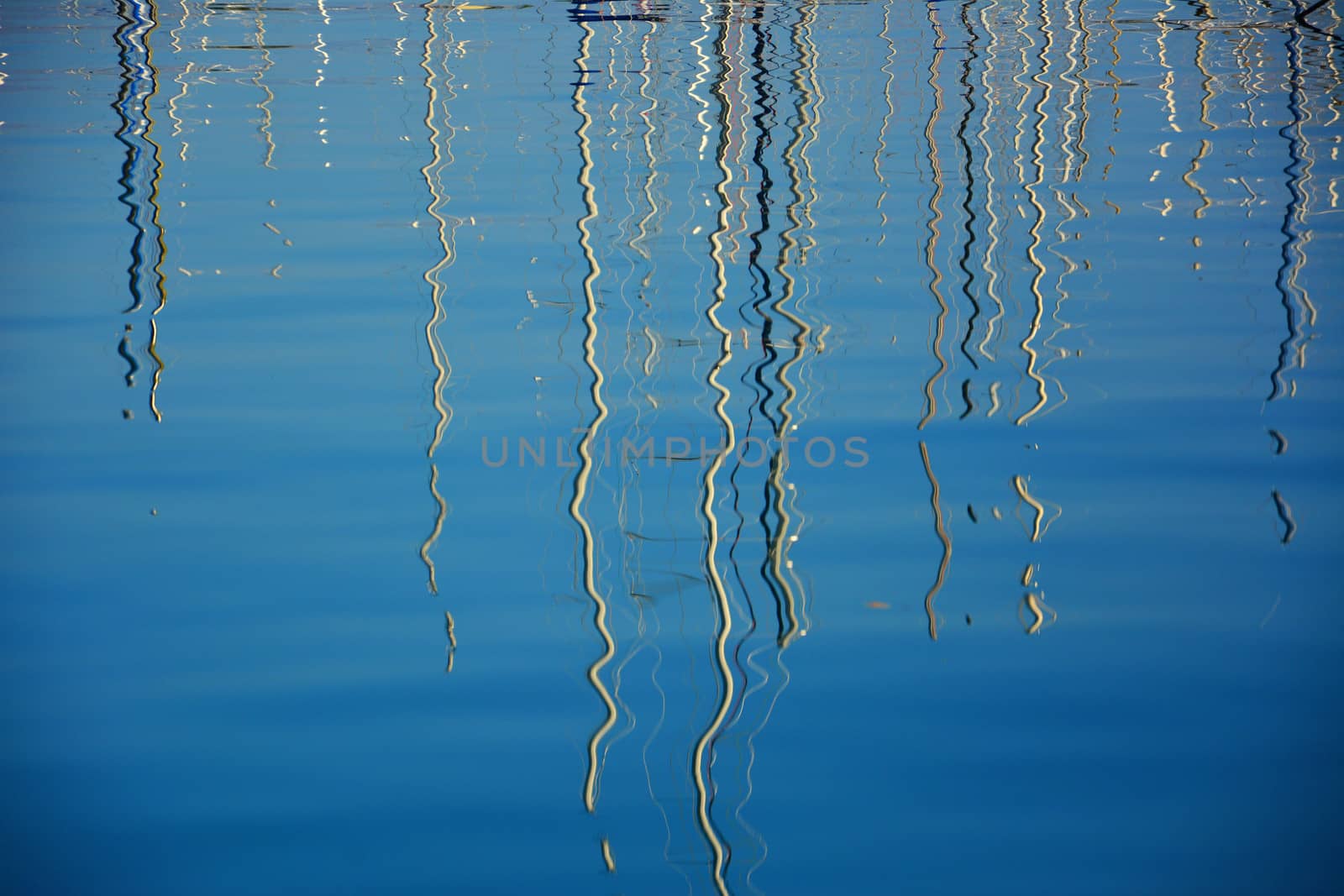 boat masts reflected in water