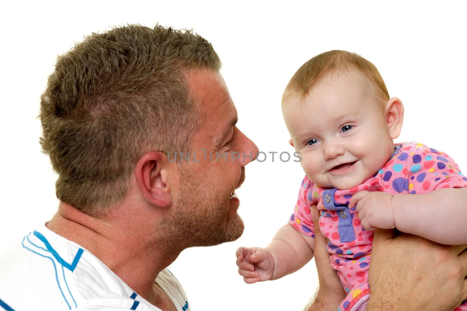 Baby and father are playing. They are both smiling and are very happy together.  The baby 3 month old. Isolated on a white background.