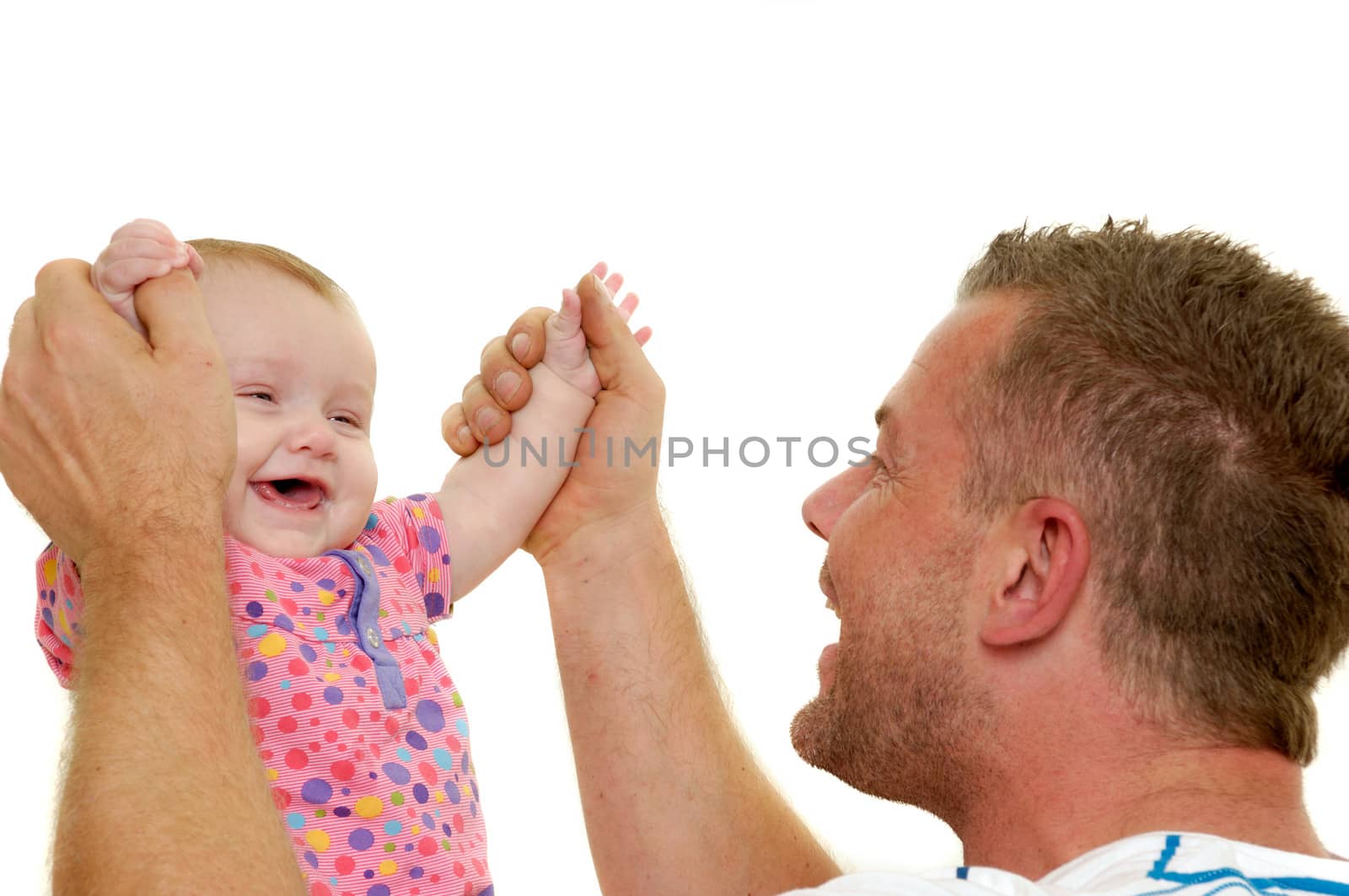 Baby and father are playing. They are both smiling and laughing and are very happy together.  The baby 3 month old. Isolated on a white background.