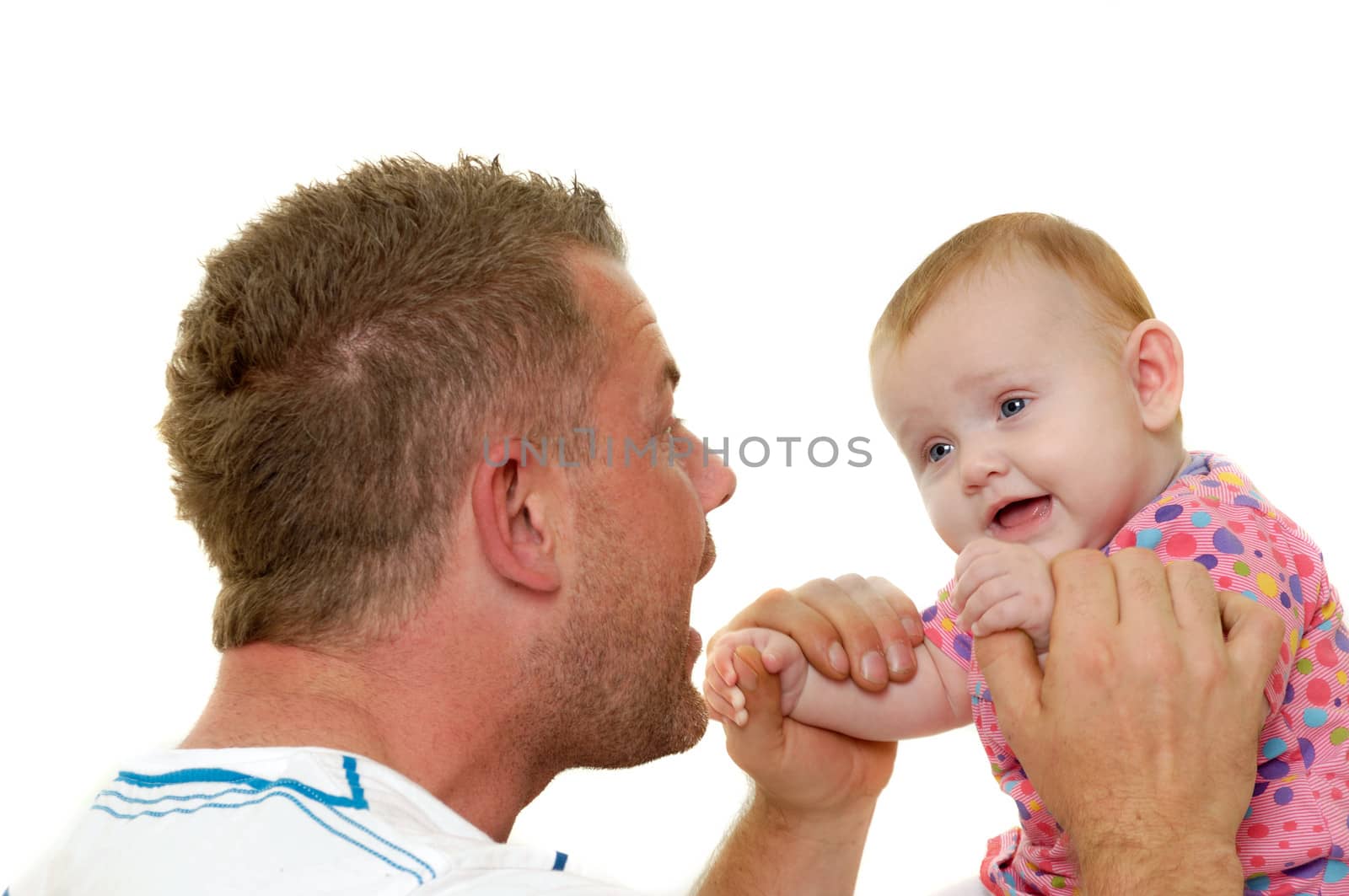 Baby and father are playing. They are both smiling and are very happy together.  The baby 3 month old. Isolated on a white background.