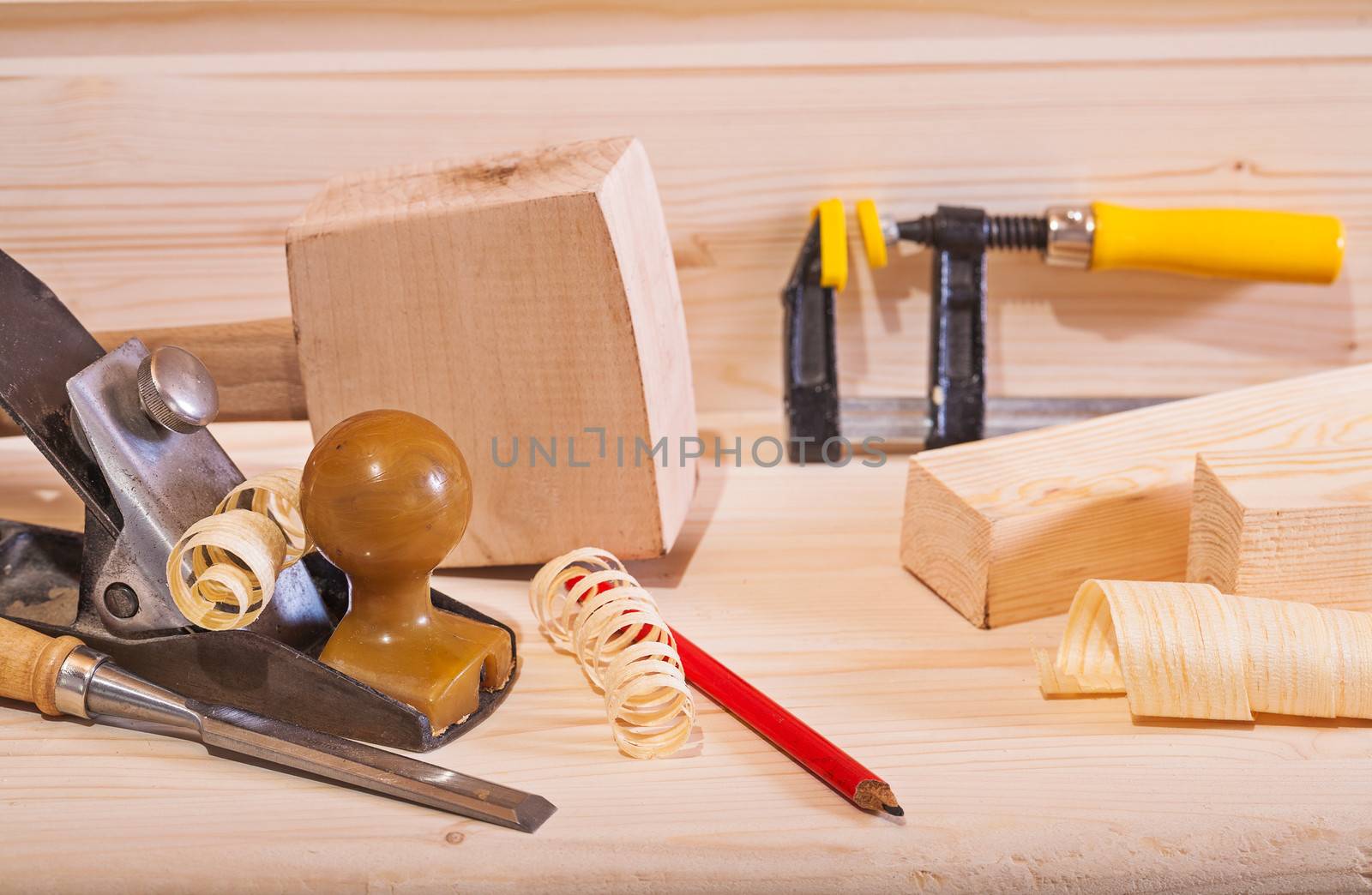 woodworking plane with other tools on wooden board