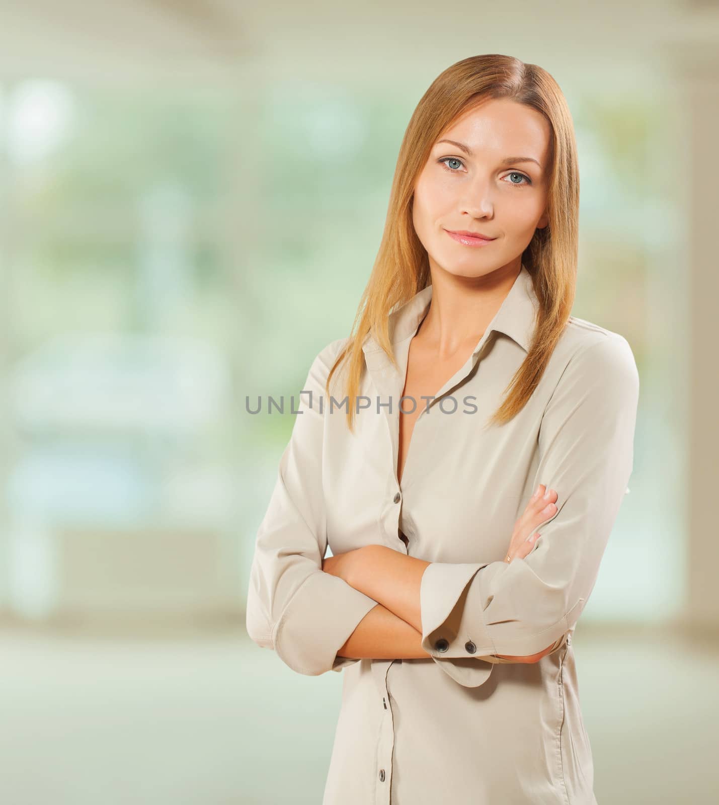 portrait of beautiful businesswoman with crossed arms by mihalec