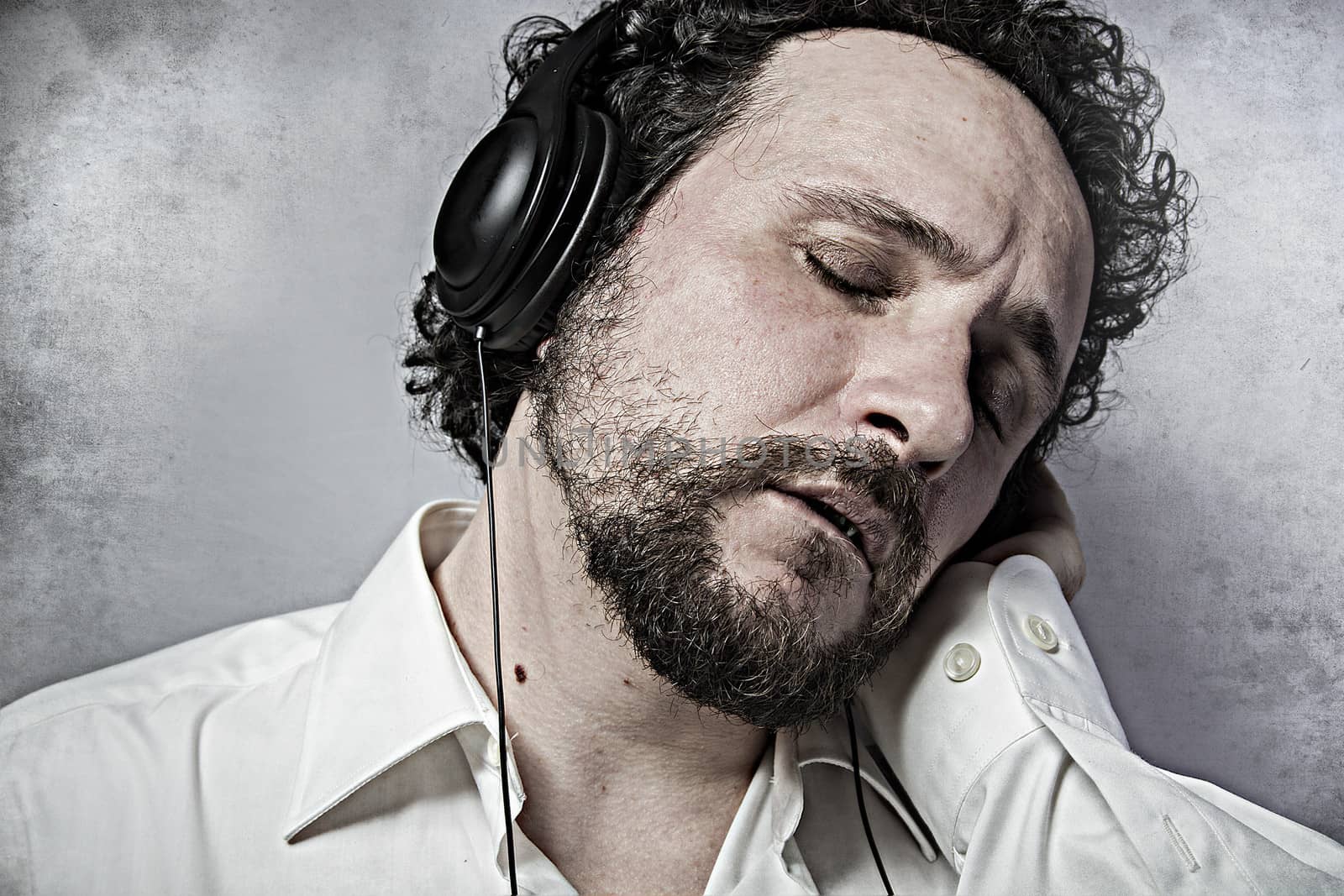 Joy, listening and enjoying music with headphones, man in white by FernandoCortes