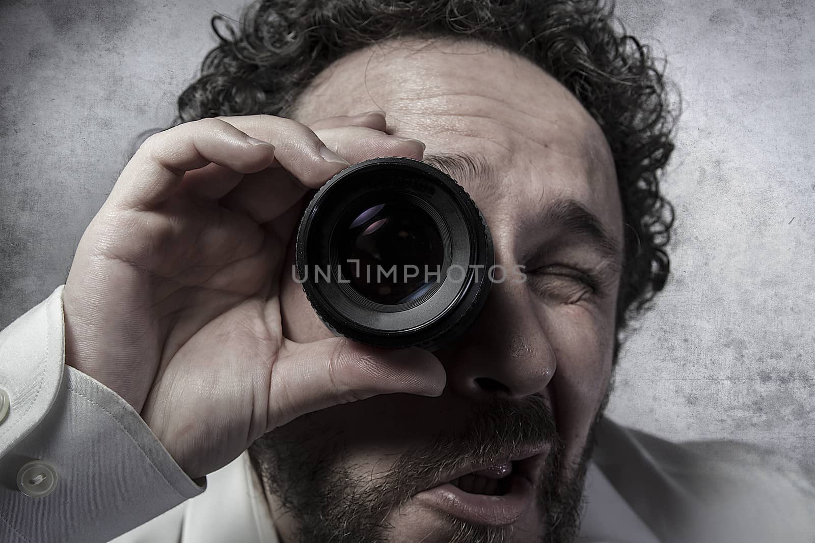 Businessman looking through a lens, man in white shirt with funn by FernandoCortes