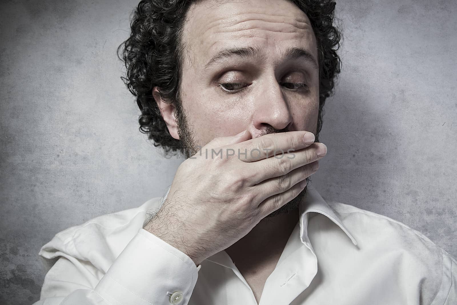 Businessman covering his emouth, man in white shirt with funny e by FernandoCortes