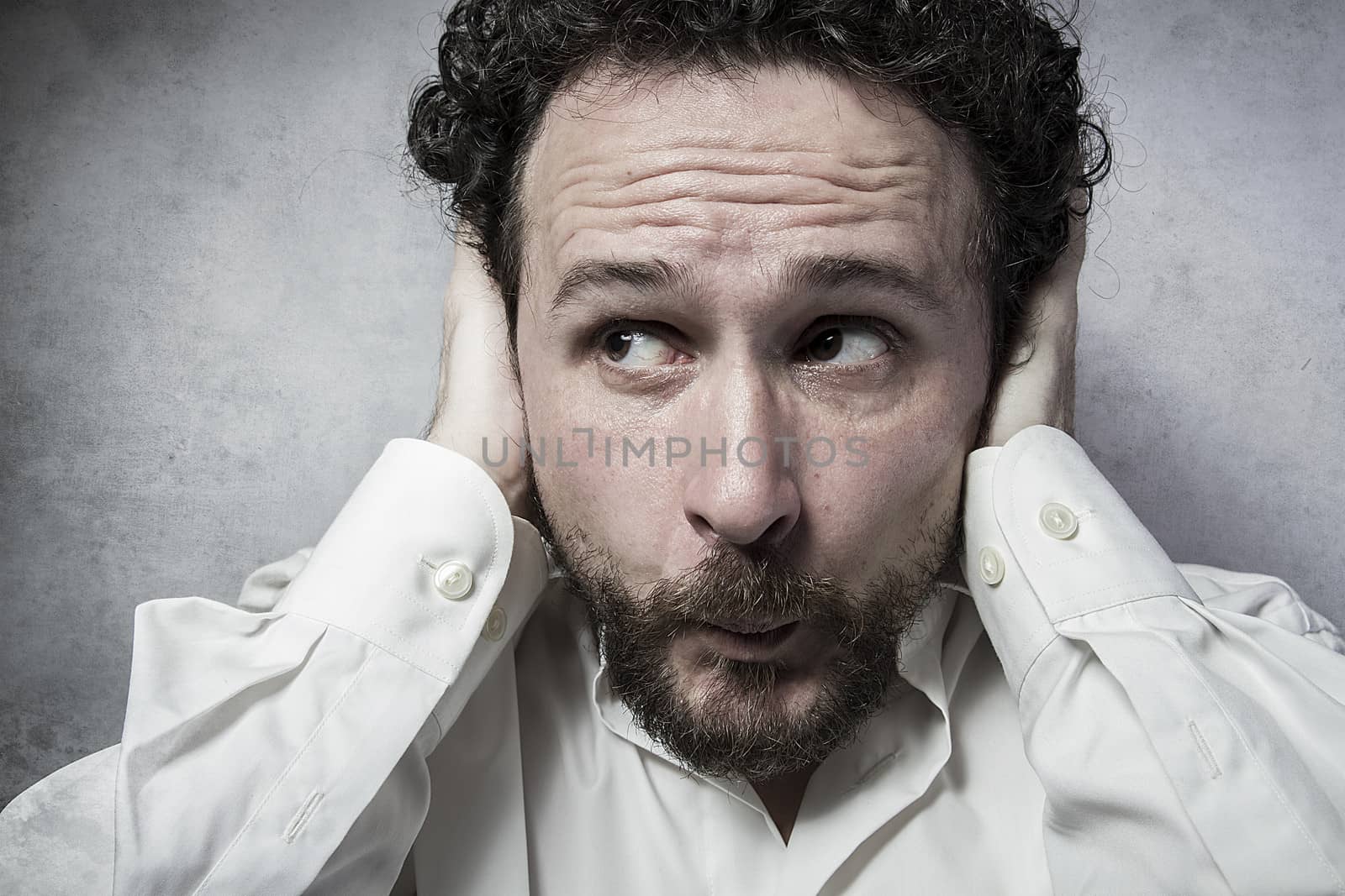 Businessman covering his ears, man in white shirt with funny exp by FernandoCortes