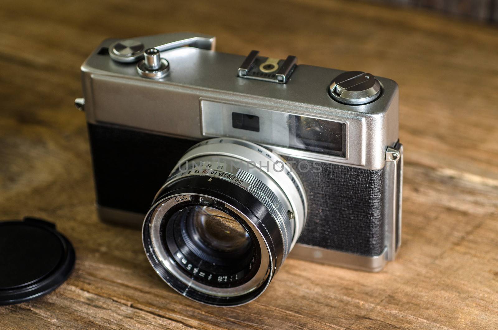 Vintage camera on wooden background.