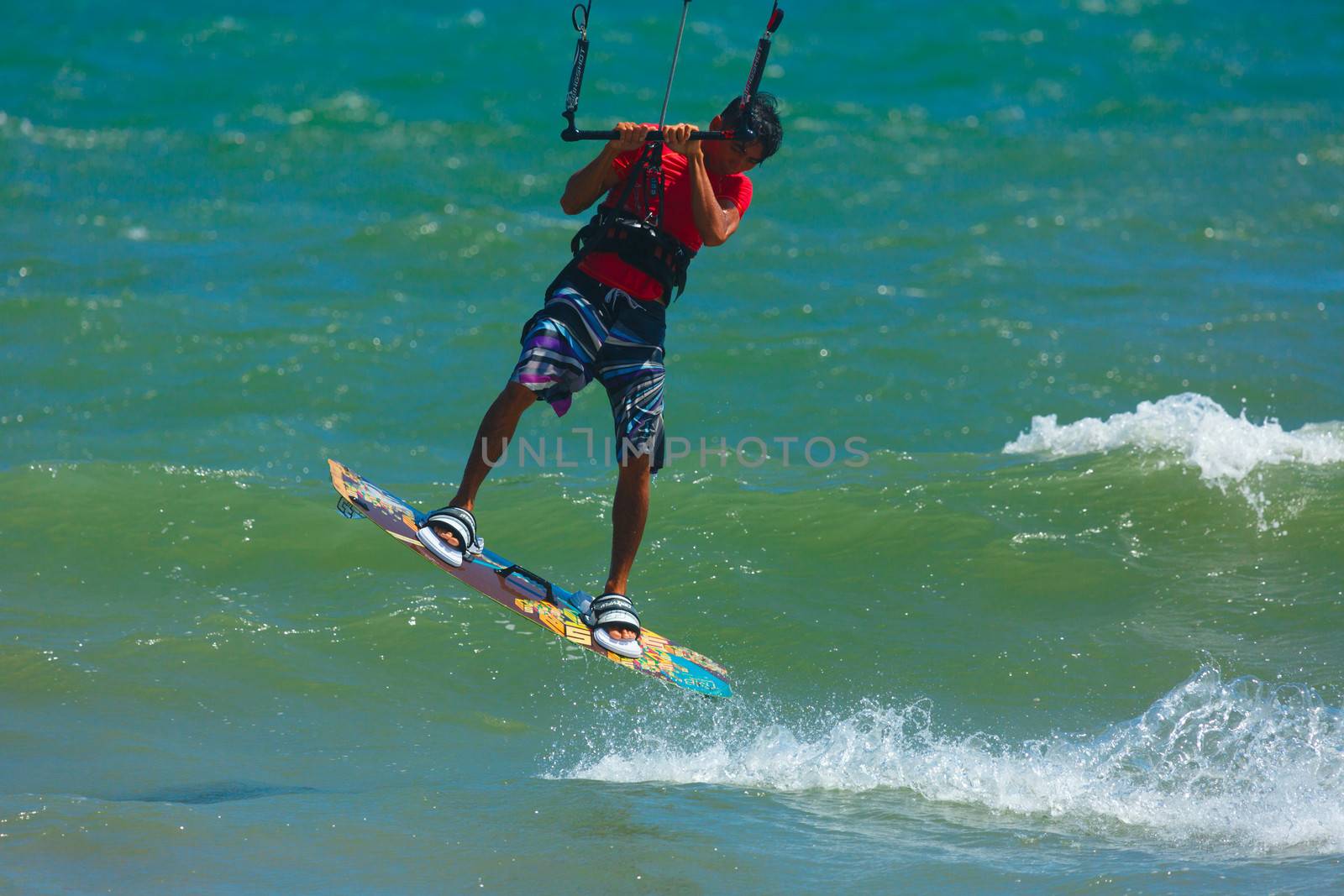 MUI NE, VIETNAM - JANUARY 29, 2014: Unidentified kitesurfer at Mui Ne resort beach on January 29, 2014 in Mui Ne resort, Vietnam.