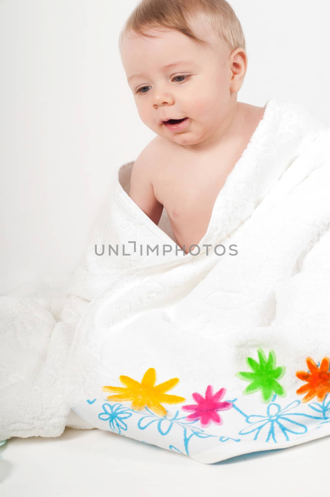 Baby boy in a white floral towel