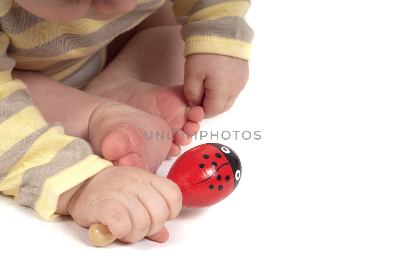 Baby keeping red toy in the hand