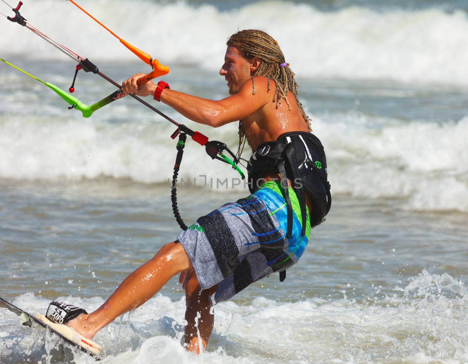 MUI NE, VIETNAM - JANUARY 31, 2014: Unidentified kitesurfer at Mui Ne resort beach on January 31, 2014 in Mui Ne resort, Vietnam.