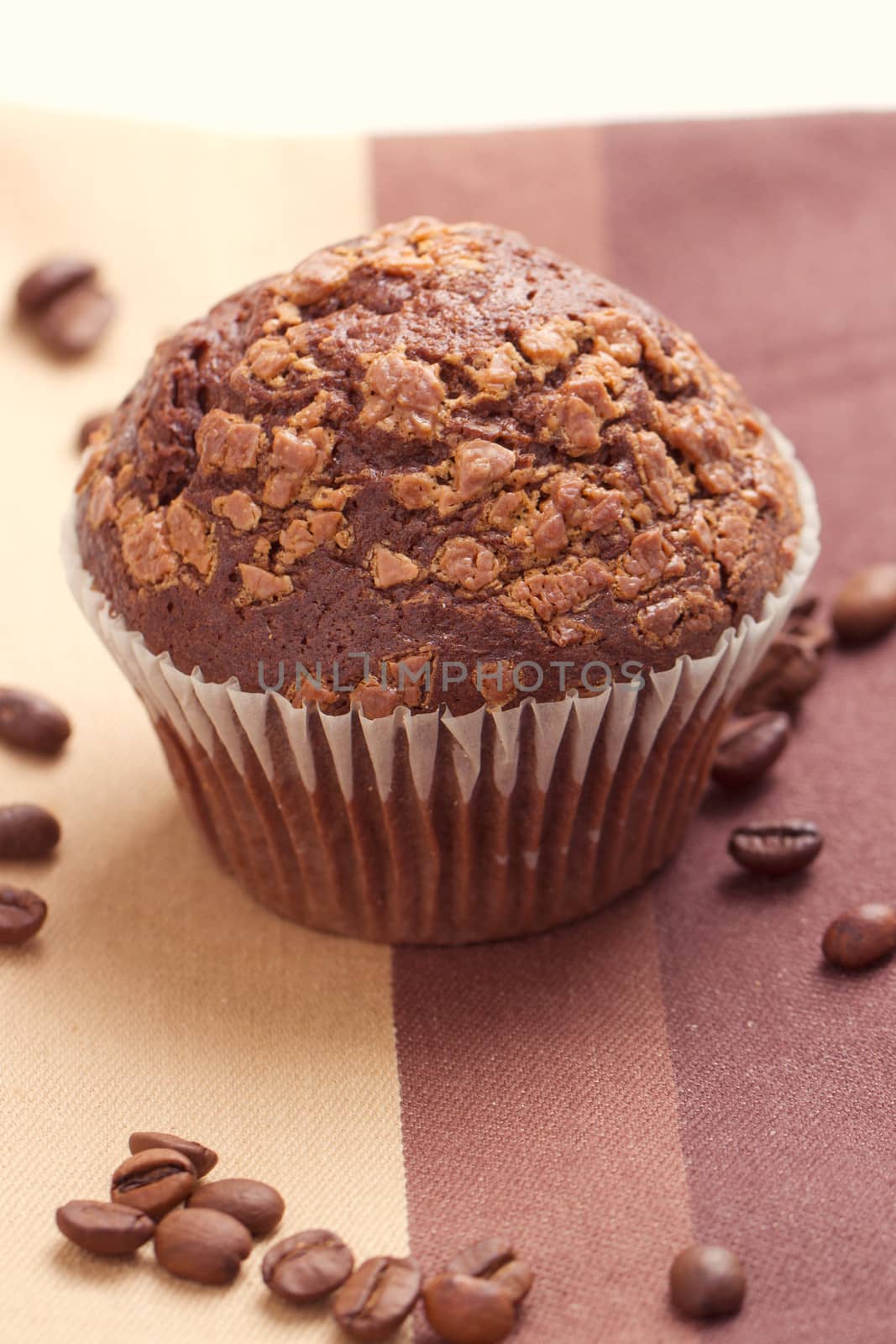 Chocolate muffins and coffee beans on the table