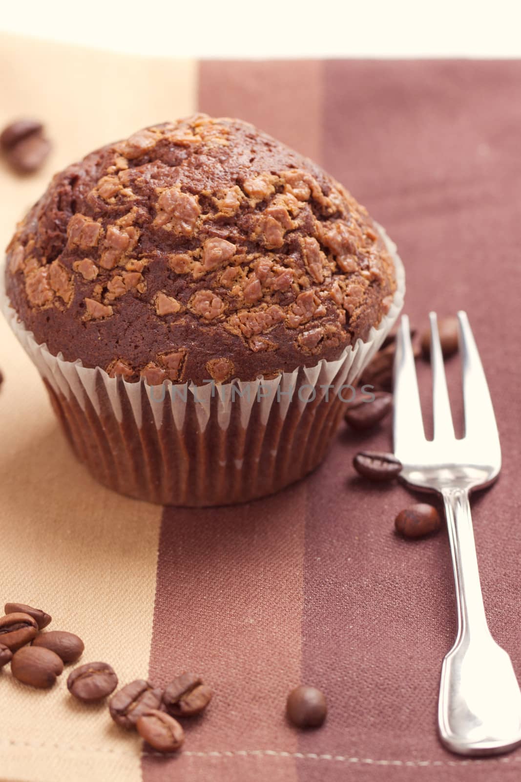 Chocolate muffins and coffee beans on the table