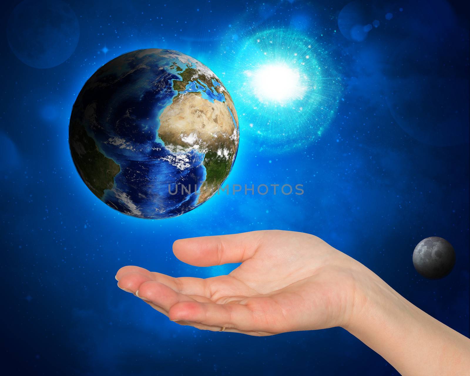 Hand holding earth. Starry sky in the background