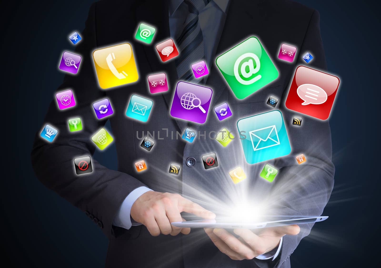 Man in suit holding tablet pc and application icons in hand. The concept of software