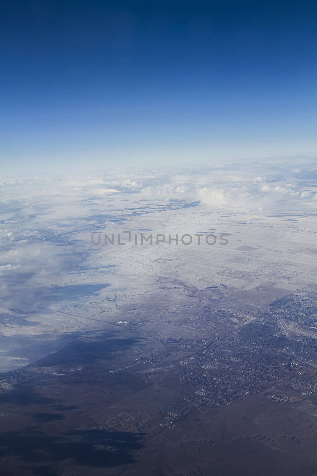 Arial view of the western USA, seeing snow covered land going to desert condition 