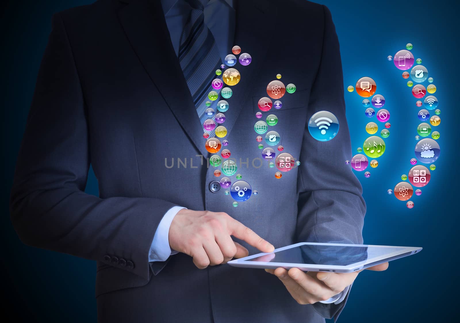 Businessman in a suit holding a tablet in his hands. Above the screen tablet application icons in the form of wi-fi icon
