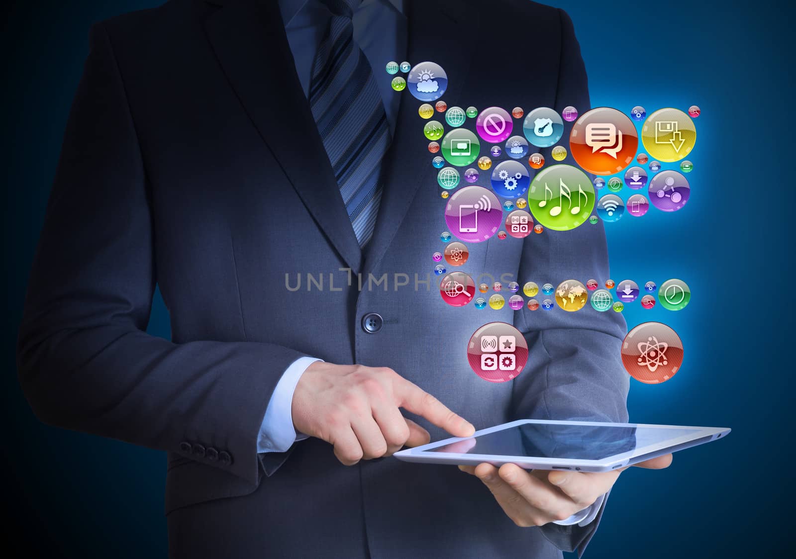 Businessman in a suit holding a tablet in his hands. Above the screen tablet application icons in the form of trolley