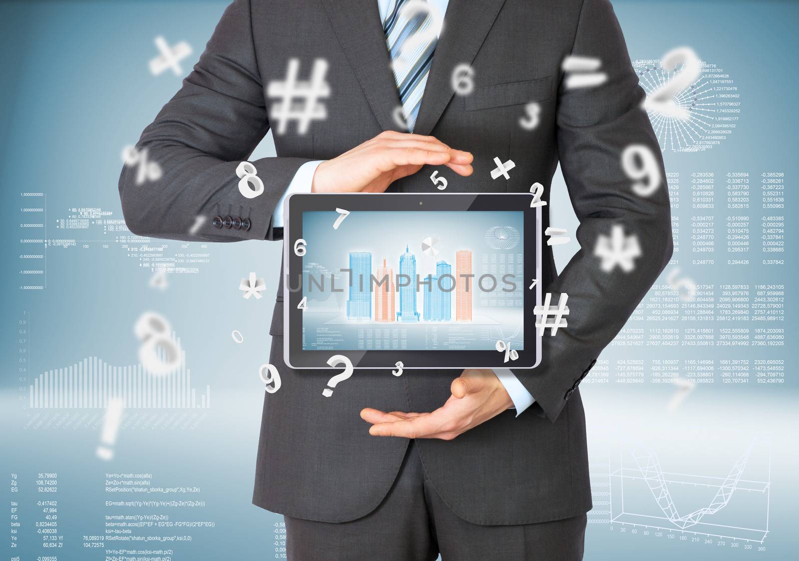 Businessman in a suit holding a tablet computer. Graphs and figures on background