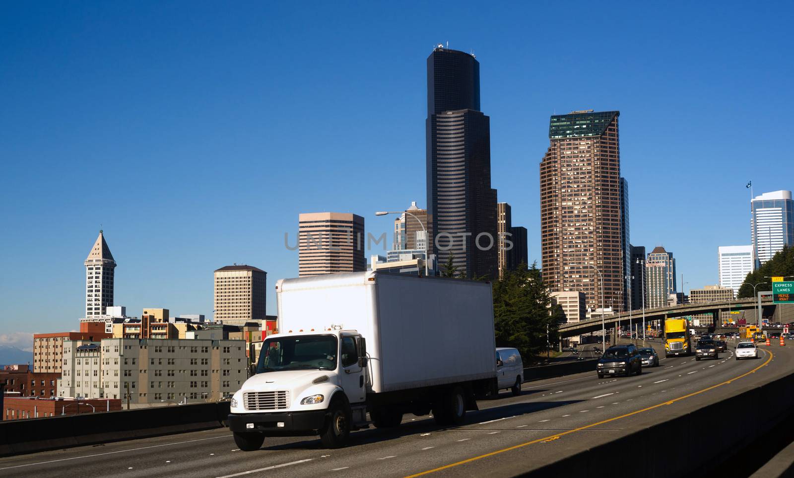 Vehicles travel down Interstate 5 infron of Seattle Downtown