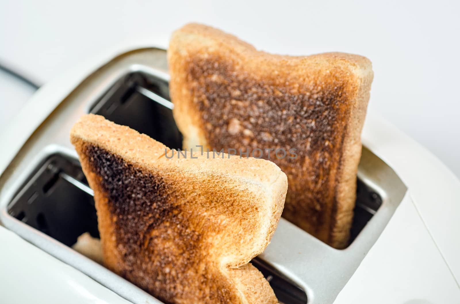 Close up of Toast in a toaster Path  ; does not include shadow under toaster