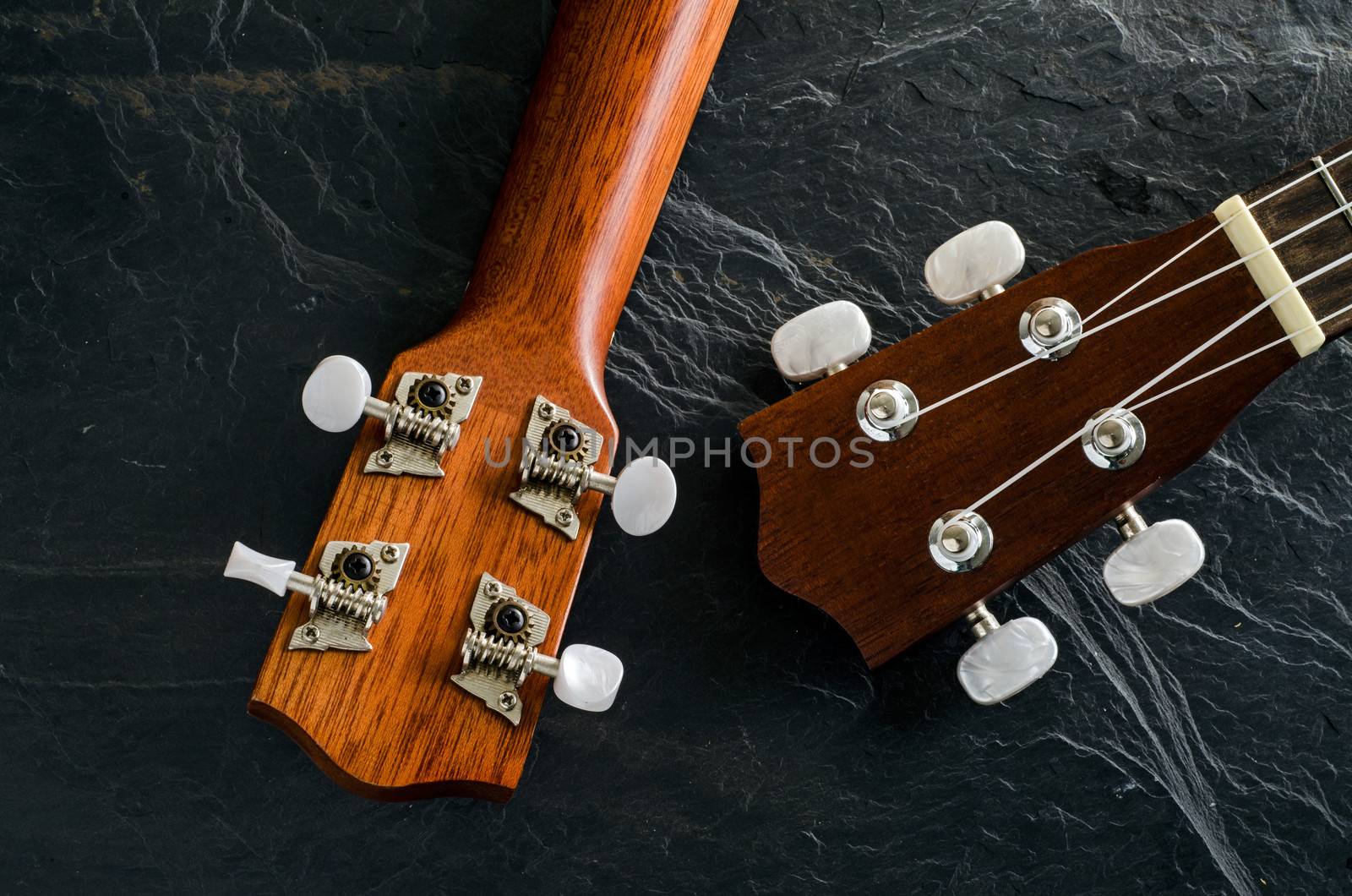 ukulele against a stone  background.