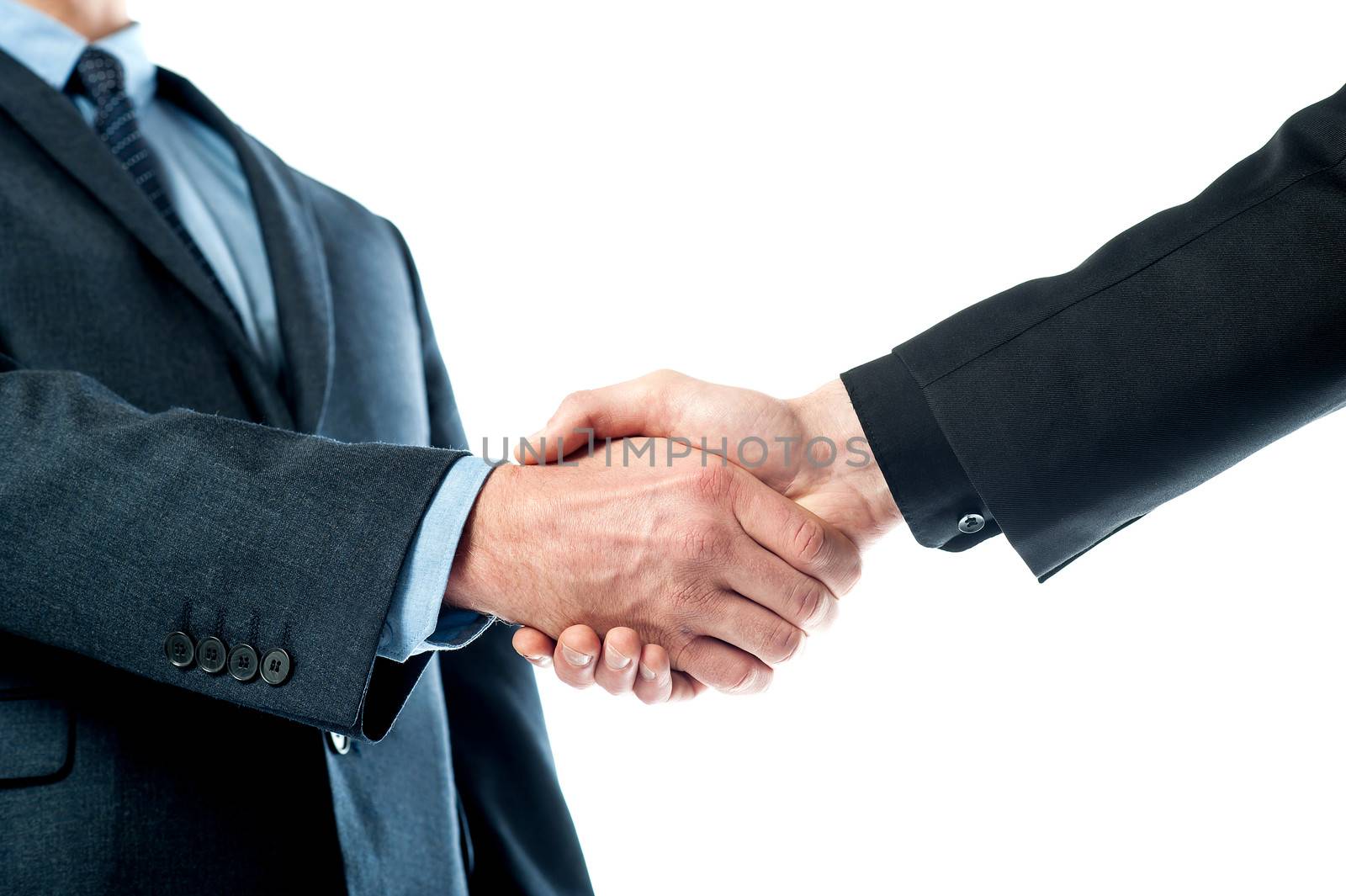Closeup of business people shaking hands by stockyimages