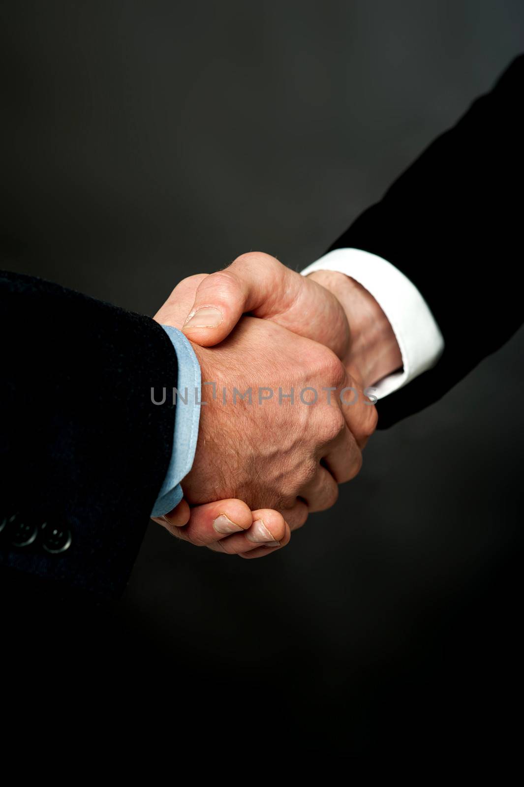 Closeup of a business handshake by stockyimages