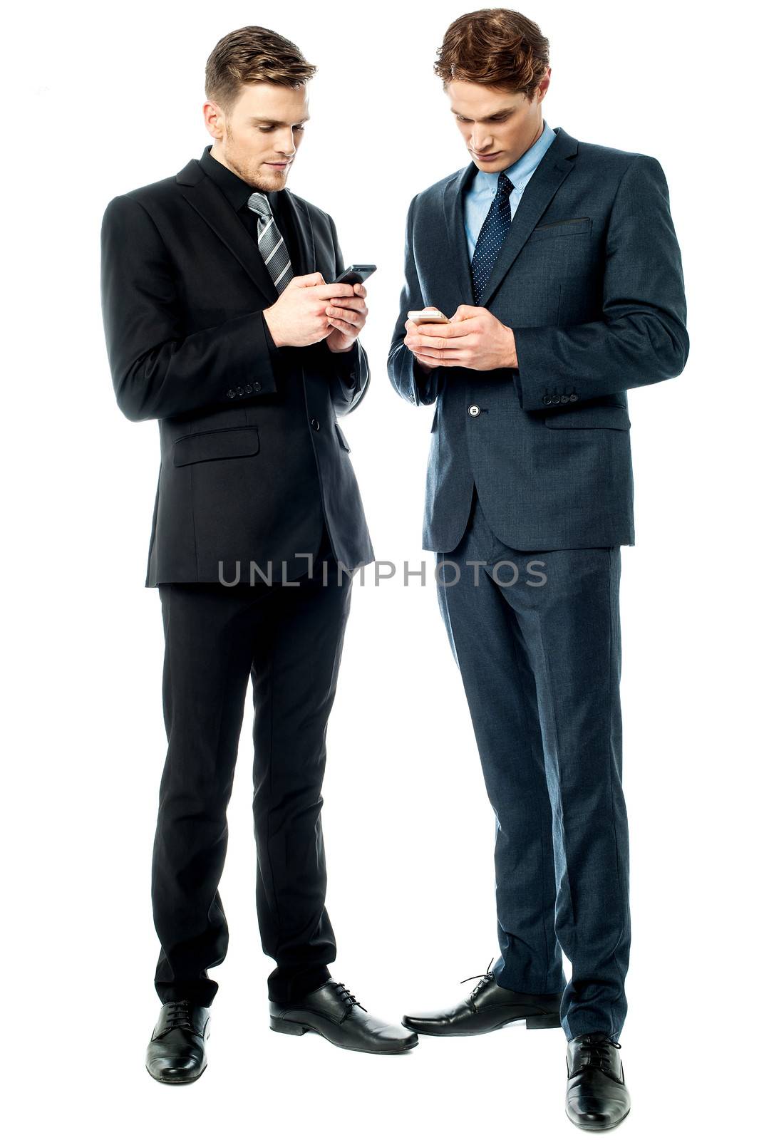 Two businessmen using the phone by stockyimages