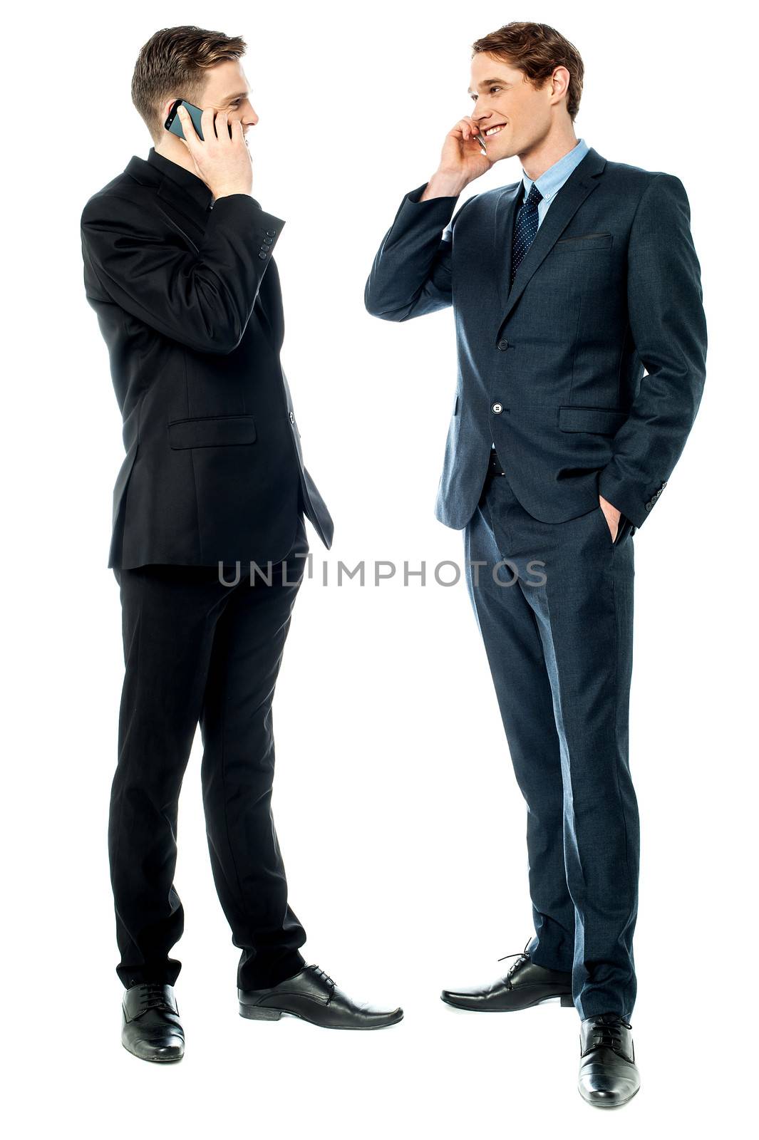 Business people communicating via cellphone