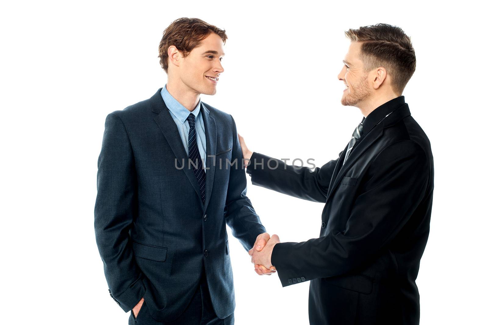 Successful partners shaking hands by stockyimages