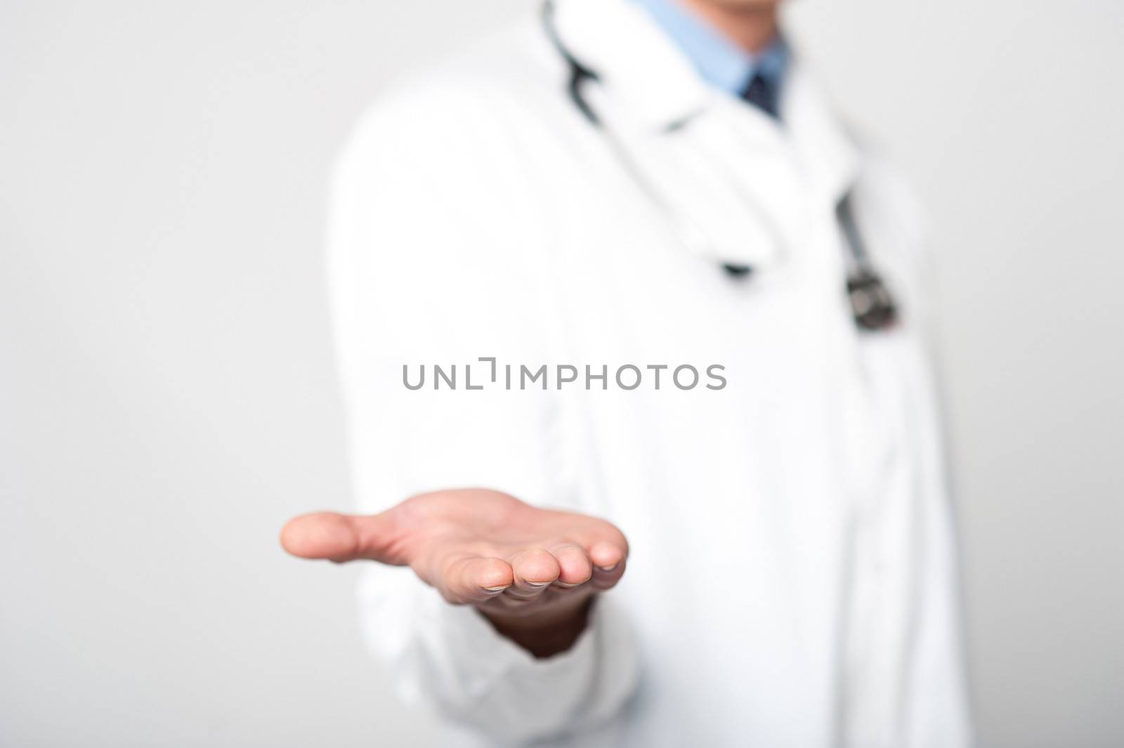 Cropped image of male doctor shows his palm to camera