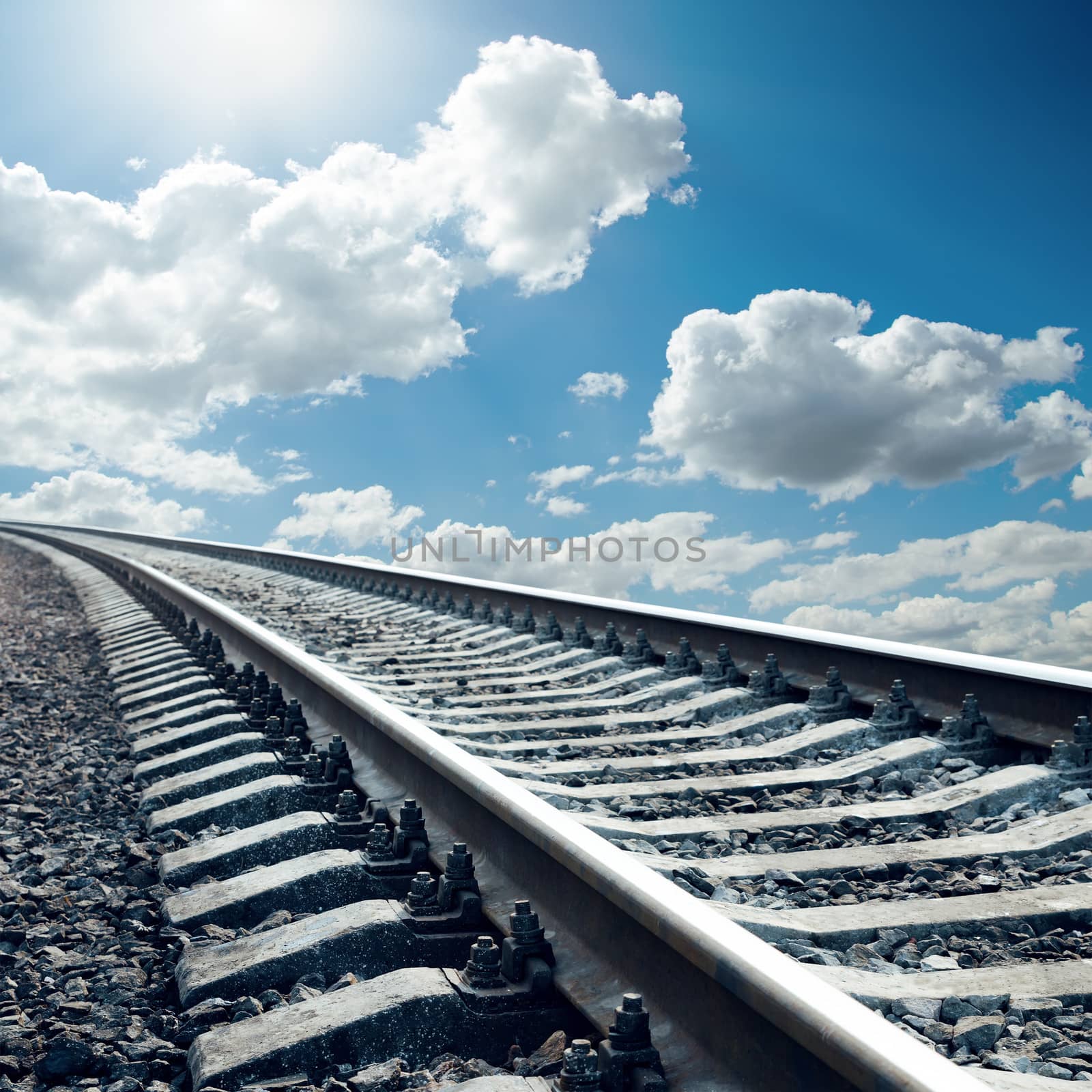 railroad closeup to horizon in sky with sun by mycola