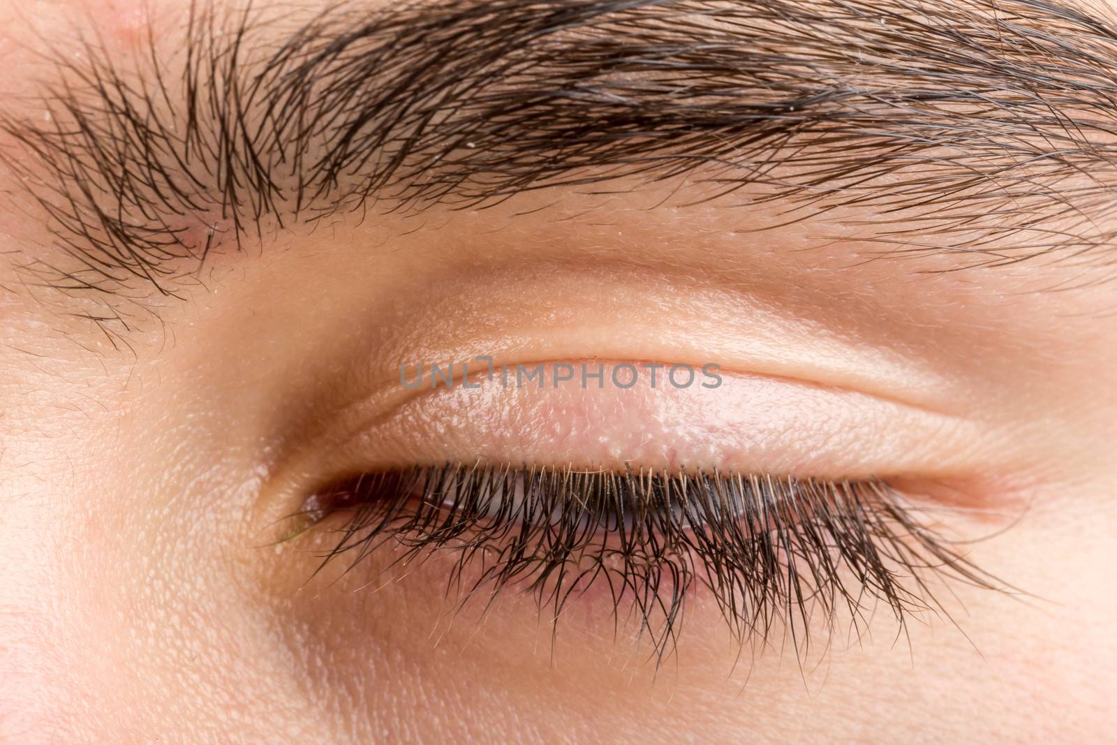 shoot of beautiful teenager man closed eye macro