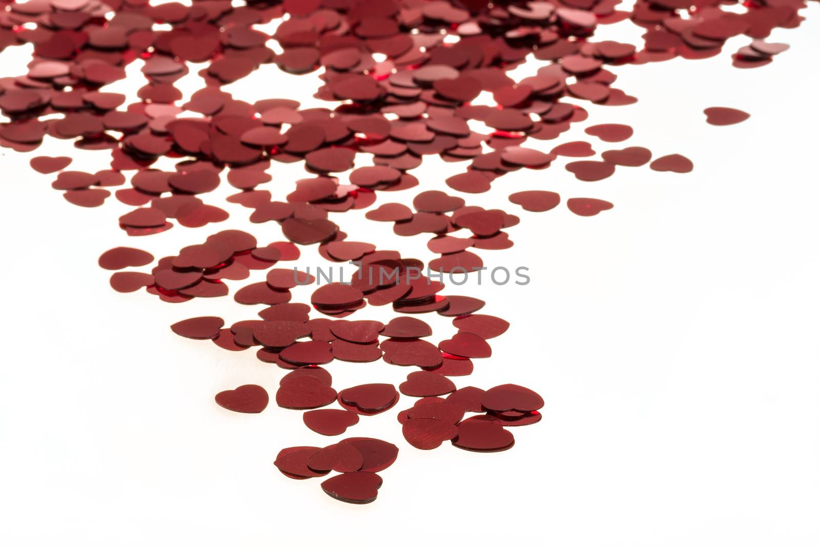 small red hearts confetti isolated on white background